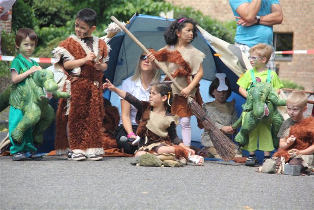 Kinder als Drachen und Steinzeitjäger verkleidet.